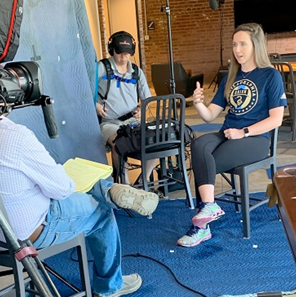 Nutrition Alum Respond to COVID-interviewed in front of a camera crew